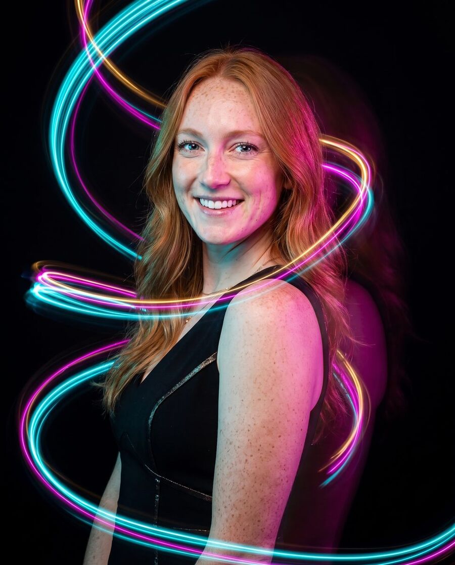Neon light-painting — studio black, ribbons of colour
